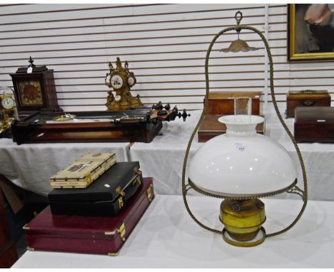 Brass and glass hanging oil lamp "The Century Lamp", having spirally twisted brass pear-shaped frame and with white opaline g