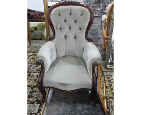 Victorian mahogany balloon back nursing chair, the shew frame carved with flowers over green button back upholstery 