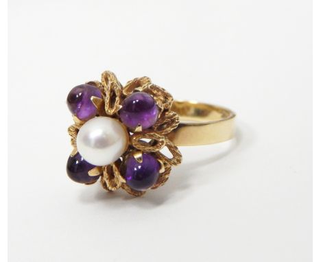 Gold coloured amethyst and cultured pearl dress ring, the central cultured pearl surrounded by four cabochon amethysts by Tom