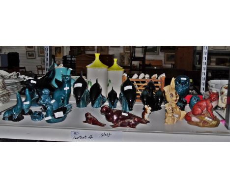 Quantity of Poole models including seals, leaping dolphins, an otter, owls, a cat, a frog, all in dark blue and teal, model o