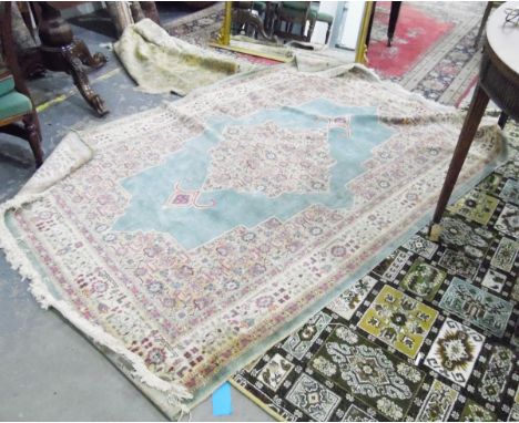 Eastern carpet, with central medallion on a light green ground within cream borders of flowerheads and another rug in greens 