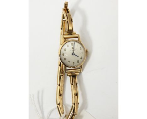 Lady's Tissot gold-coloured strap watch on rolled gold expanding bracelet, in Tissot box and a 9ct gold wedding ring with eng