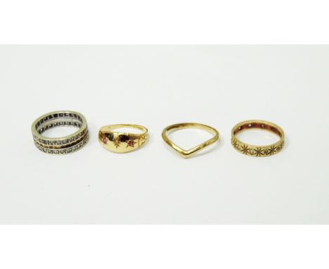 18ct gold ruby and diamond set gypsy ring, a 9ct gold wishbone wedding band, a 9ct gold eternity ring set with clear stones a