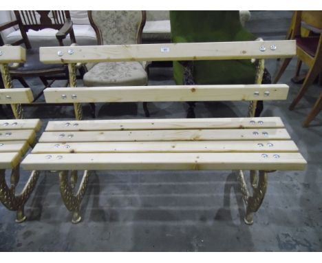 Pair of pine slat back and seated garden bench seats on gilt painted ornate cast iron supports, stylised snake design 