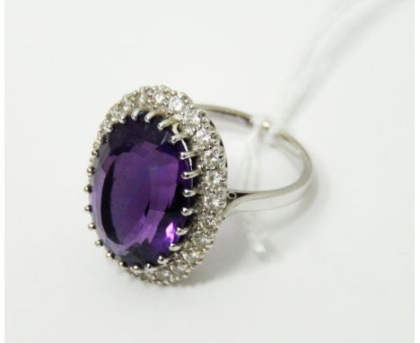 White gold-coloured amethyst and diamond cluster ring, the central oval mix-cut amethyst surrounded by brilliant cut diamonds