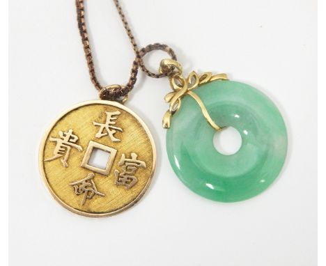 Chinese gold-coloured disc pendant, decorated with characters, marked 14K and 585, approx.5.8gm and a jade disc pendant with 
