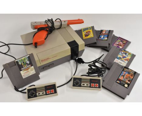 Vintage Computing/Gaming - a 1980s Nintendo Entertainment System (NES) games console, 2 controllers, Zapper gun ans sic cartr