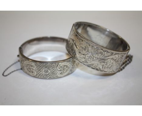 A HALLMARKED SILVER ENGRAVED BANGLE TOGETHER WITH ANOTHER