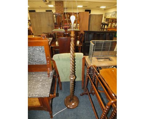 A CIRCA 1930'S OAK BARLEYTWIST TAPERED LAMP STANDARD