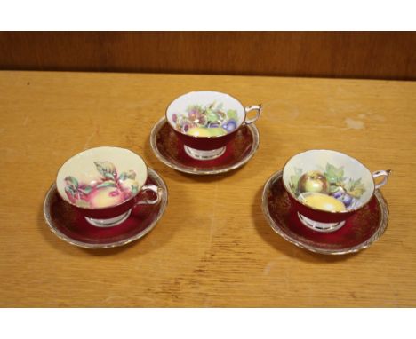 THREE PARAGON CHINA CUPS AND SAUCERS WITH INTERIOR FRUIT PATTERN 