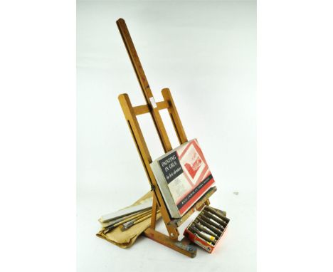 An artist's easel, paints and brushes 