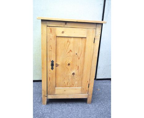 A vintage single door pine cupboard, opening to reveal two shelves, 90 cm high x 60 cm wide 