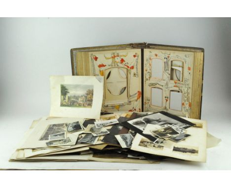 A Victorian photograph album with a large collection of loose vintage photos