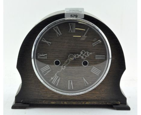 A mid century oak Smiths mantel clock, the dial with Roman numerals denoting hours, 21cm high