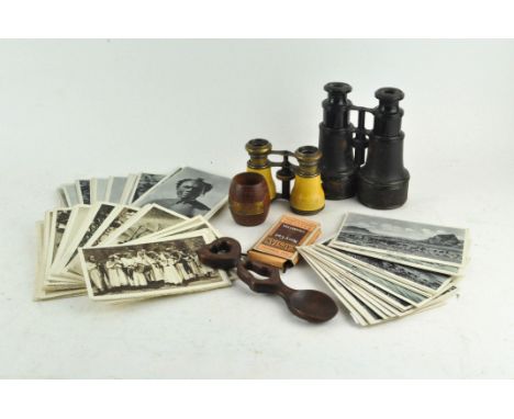 A collection of Vintage ethnographic postcards, a teak barrel-shaped HMS Queen Elizabeth Dardanelles salt, a carved Welsh lov