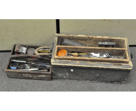 A selection of tools in a wooden box and tray, including pliers, spirit level and more