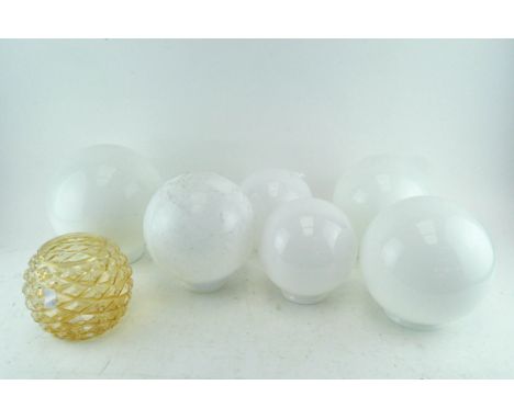 A collection of six milk glass globe shape light shades and another in pale gold (7)