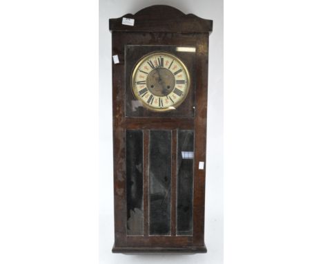 A 20th century oak cased wall clock, the dial with Roman Numerals denoting hours, 90cm high