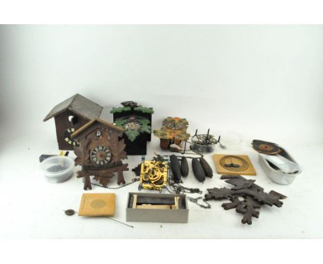 A collection of clock parts, including cuckoo parts and more