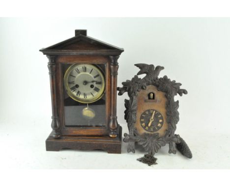 A mahogany cased mantel clock with a temple pediment, 35cm high; and a Black Forest style cuckoo clock, 29cm high