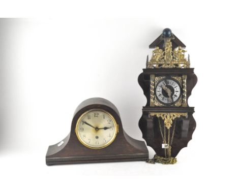 A wall clock with finial adorning the top depicting Atlas, together with an early 20th century Oak cased mantle clock