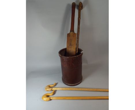 A Tooled Leather Stick Stand Containing Cricket Bat Walking Stick and Two Elephant Head Shepherds Crooks.