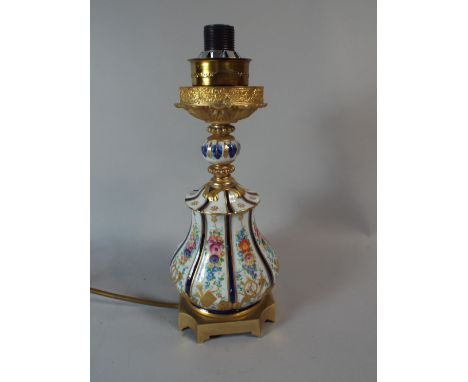 A French Porcelain and Ormolu Table Lamp  Decorated with Flowers and Musical Instruments. 