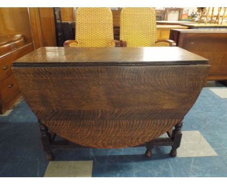 An Oak Gate Leg Drop Leaf Dining Table. 