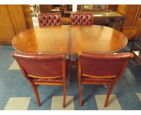 An Extending Yew Wood Dining Table and Four Leather Effect Button Upholstered Dining Chairs. 