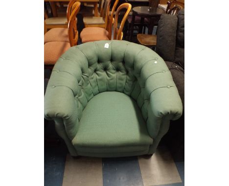 A 19th Century Button Upholstered Tub Arm Chair with Bun Feet. 
