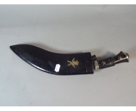 A Gurkha Kukri Knife Set in Leather Scabbard.