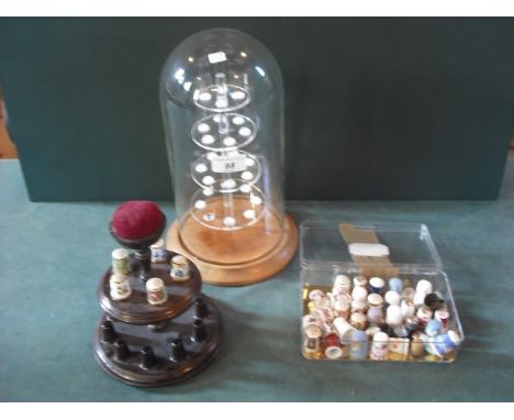 A collection of approximately two dozen largely ceramic thimbles, including Crown Derby and other factories, together with tw
