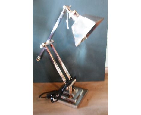 An Art Deco-style nickel plated desk lamp, having an adjustable column on stepped square foot.