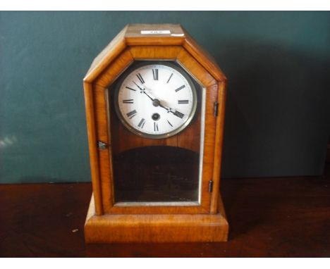 A late 19th century walnut cased mantle timepiece, the canted rectangular case enclosing eight day movement faced by enamel R