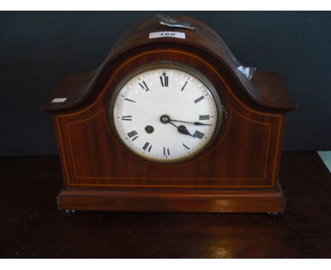 An Edwardian mahogany mantle clock, the dome top case enclosing eight day gong stringing movement faced by enamel Roman dial 