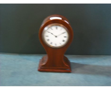 An Edwardian mahogany mantle timepiece, the balloon shape case enclosing eight day Swiss movement faced by enamel Roman dial,