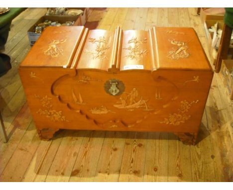 A mid-20th century Far Eastern camphor wood trunk, the top, front and sides applied with blossoming hawthorn, birds, figures 