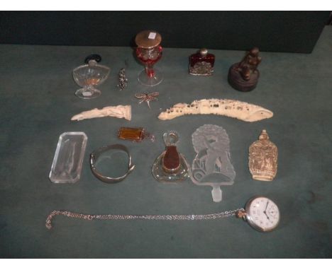 A mixed lot to include, scent bottles, moulded glass pin dish cast with a reclining nude, white metal snake bangle, costume j