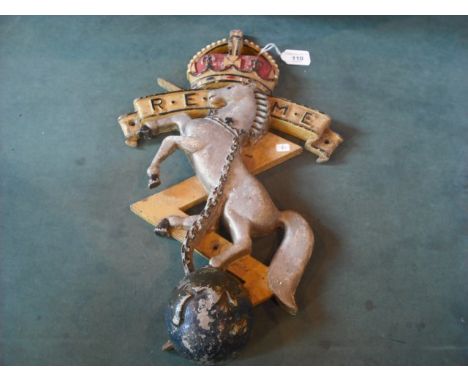 An early 20th century cast metal wall plaque for the Royal Electrical & Mechanical Engineers, decorated with chained prancing
