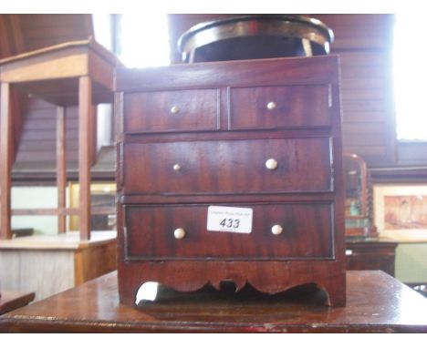 A 19th century miniature mahogany chest of two short and two long drawers on bracket plinth.