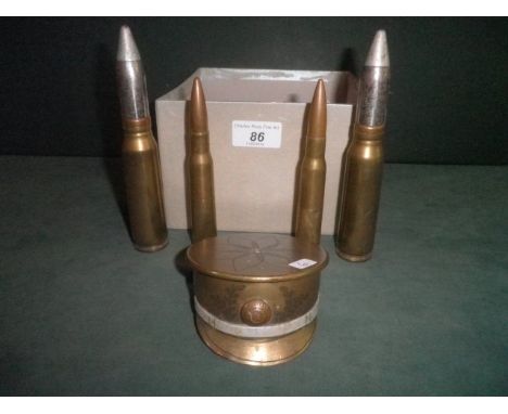A small collection of Trench Art, including an Officer's cap, fashioned from the base of a shell case with applied badge for 