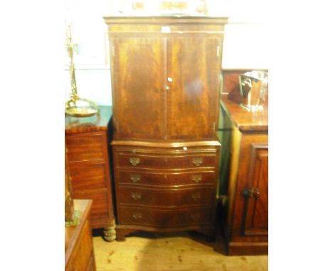 A reproduction mahogany veneered chest on chest, the serpentine top above a pair of crossbanded cupboard doors, the base with