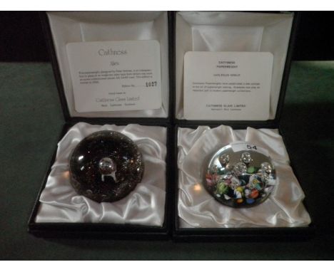 Two boxed Caithness paperweights, including a Harlequin single weight and a limited edition Alien weight, number 1027/2000.