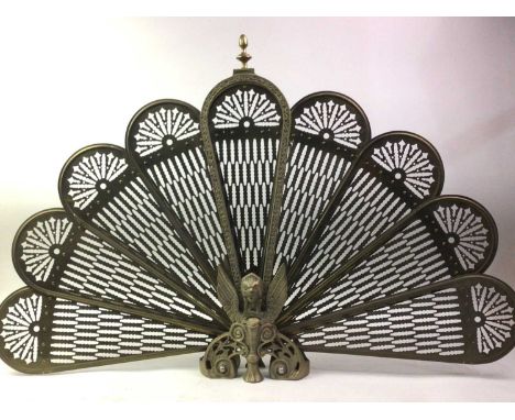 VINTAGE BRASS FIRESCREEN, modelled as a fan, on griffin support four feet62cm high 