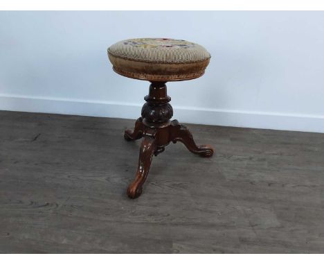 VICTORIAN REVOLVING PIANO STOOL, with upholstered seat on carved walnut supoort and tripod base