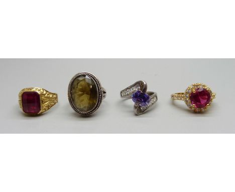 Two silver stone set rings, a silver-gilt stone set ring and a plated ring with red stone 