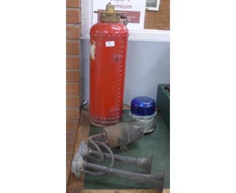 A vintage fire extinguisher (water), a blue flashing emergency light and a set of air horns 