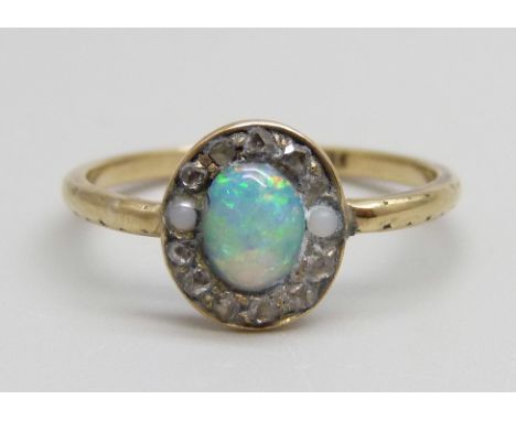 An 18ct gold, opal and old cut diamond cluster ring, two diamonds replaced by pearls, 1.9g, M 