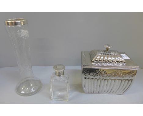 A silver topped jar, silver rimmed vase and a silver plated caddy 