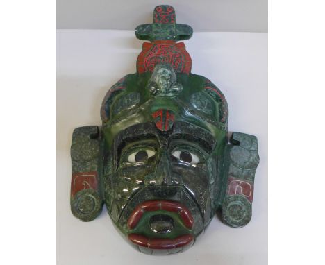 A Guatemalan mask created from resin with jade overlay, 28cm 